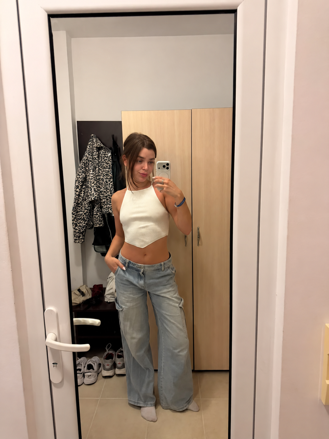 Maya in jeans and a cream top